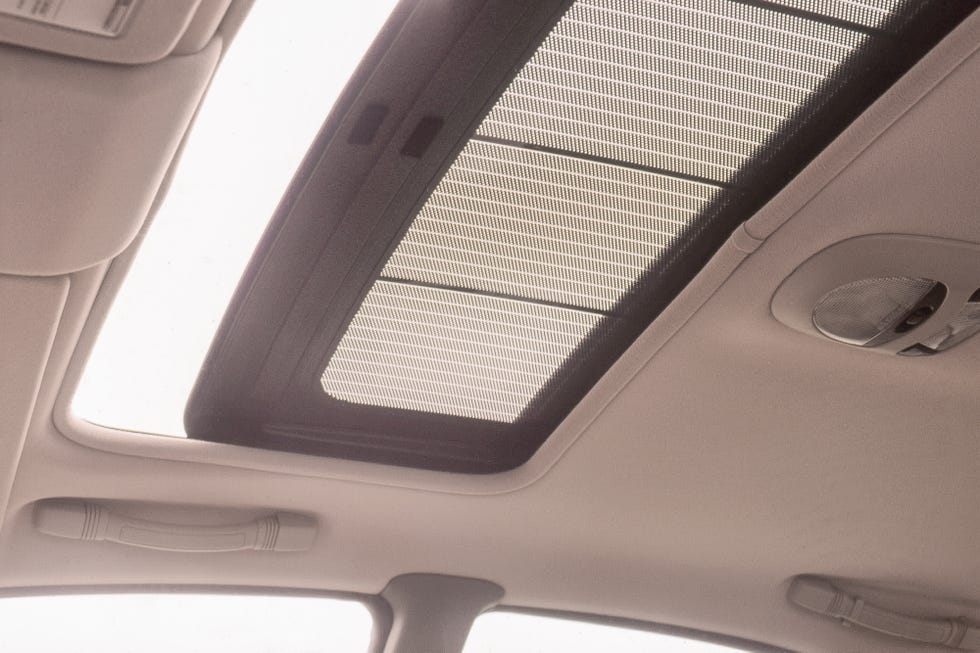 A 1992 Mazda 929 parked, showcasing its glass sunroof where solar panels were integrated.
