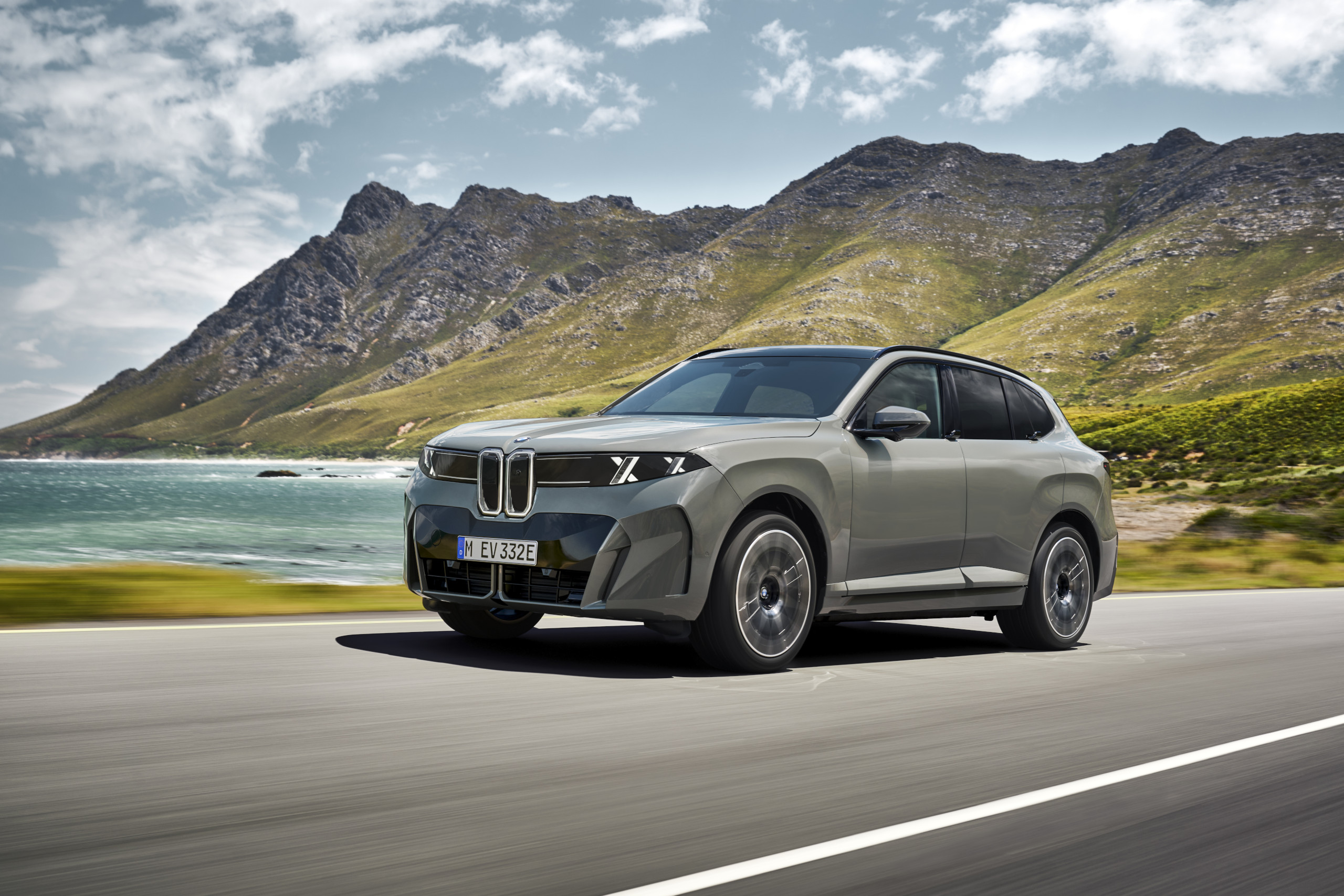 Side profile of the 2027 BMW X5 on a paved road.