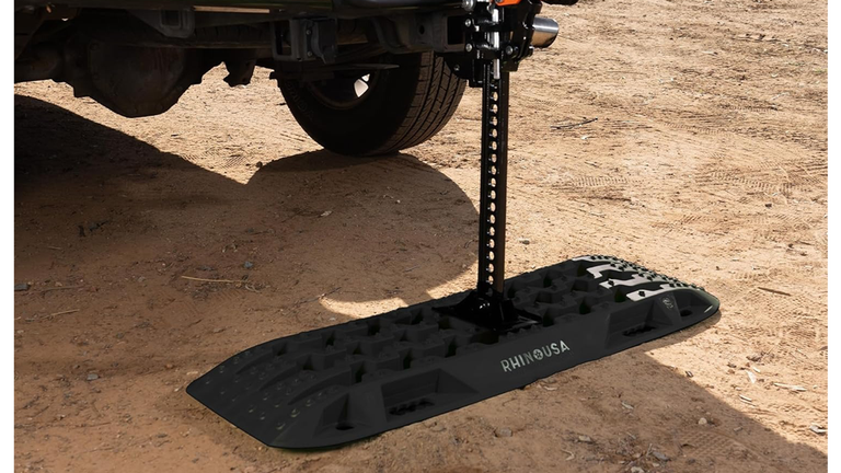 A pair of bright orange Rhino USA off-road recovery traction boards.