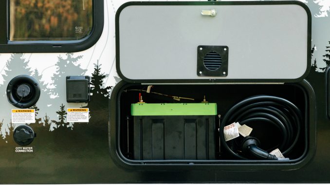 Interior view of the north-south queen bed in the cab-over section of the camper.
