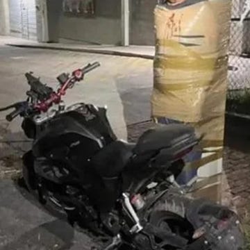 A motorcycle parked in an urban environment.