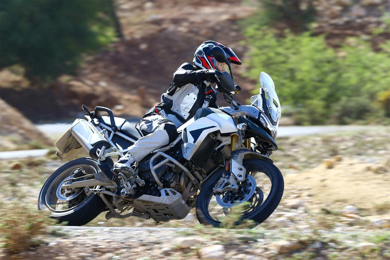 Triumph Tiger 900 adventure motorcycle in an off-road setting.