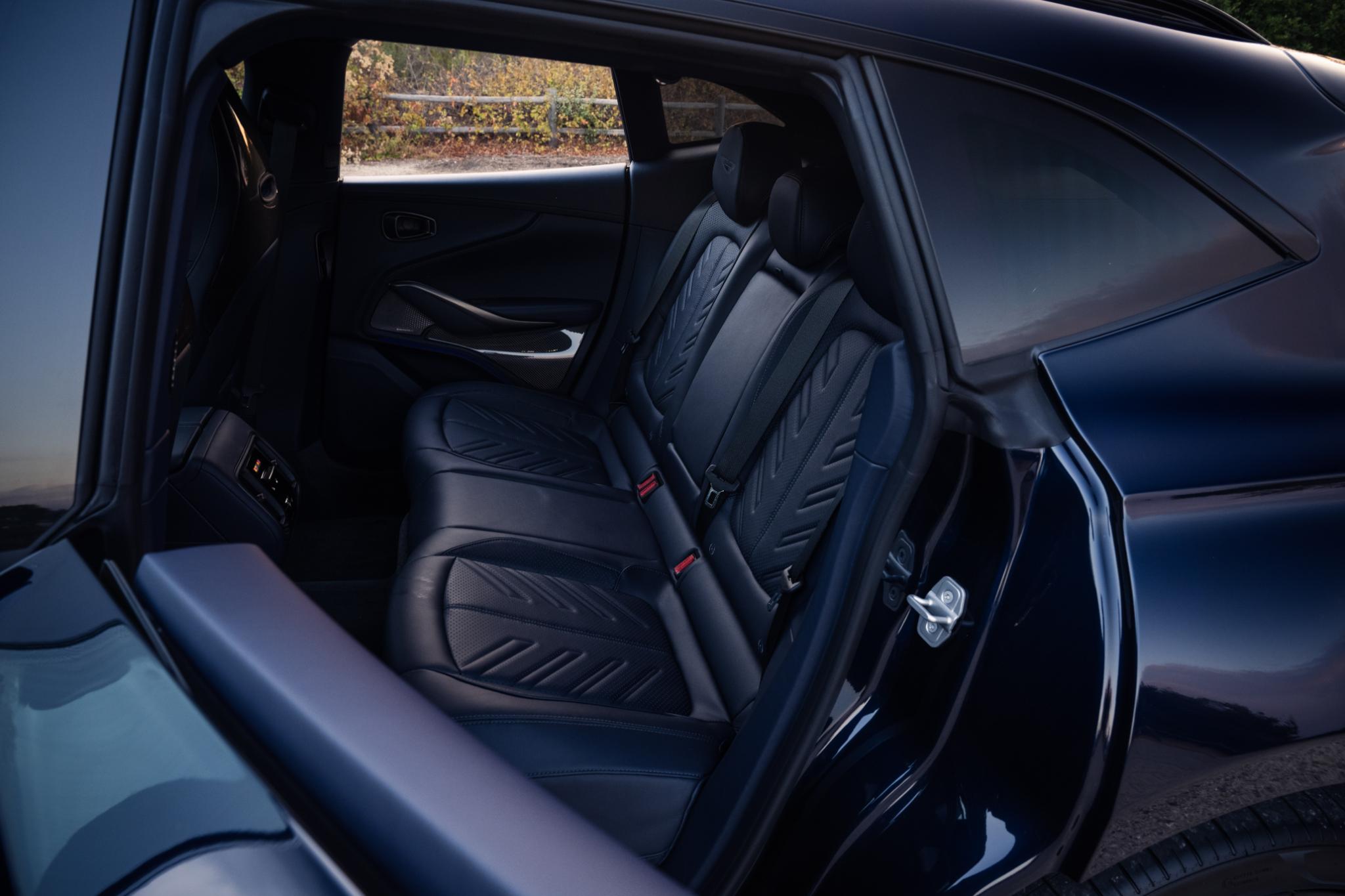 Interior dashboard of the Aston Martin DBX S highlighting the center display and climate controls.