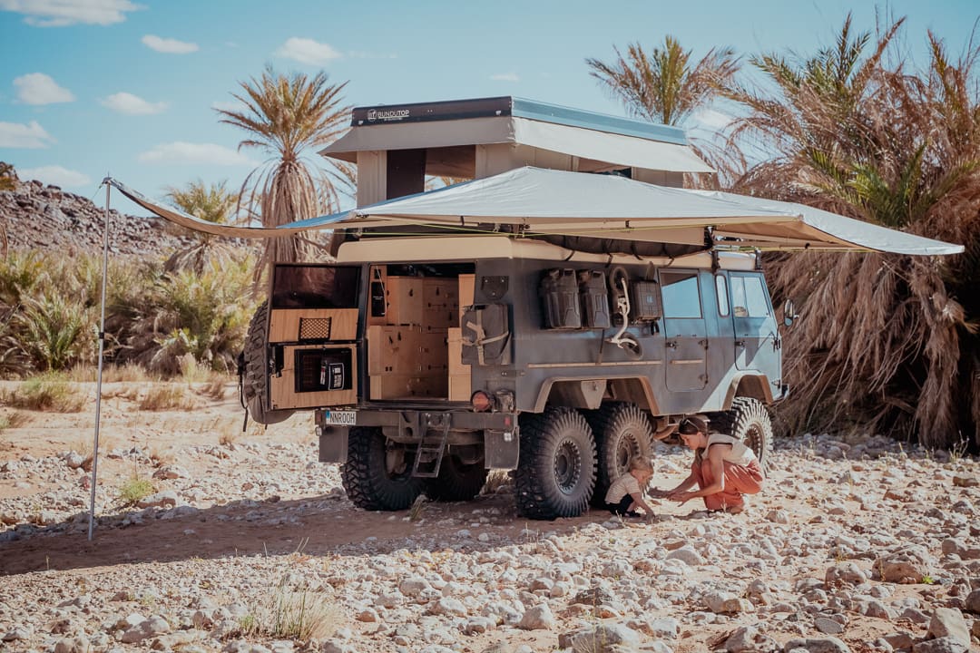 Low-angle shot focusing on the portal axles and 37-inch Maxxis Trepador tires.