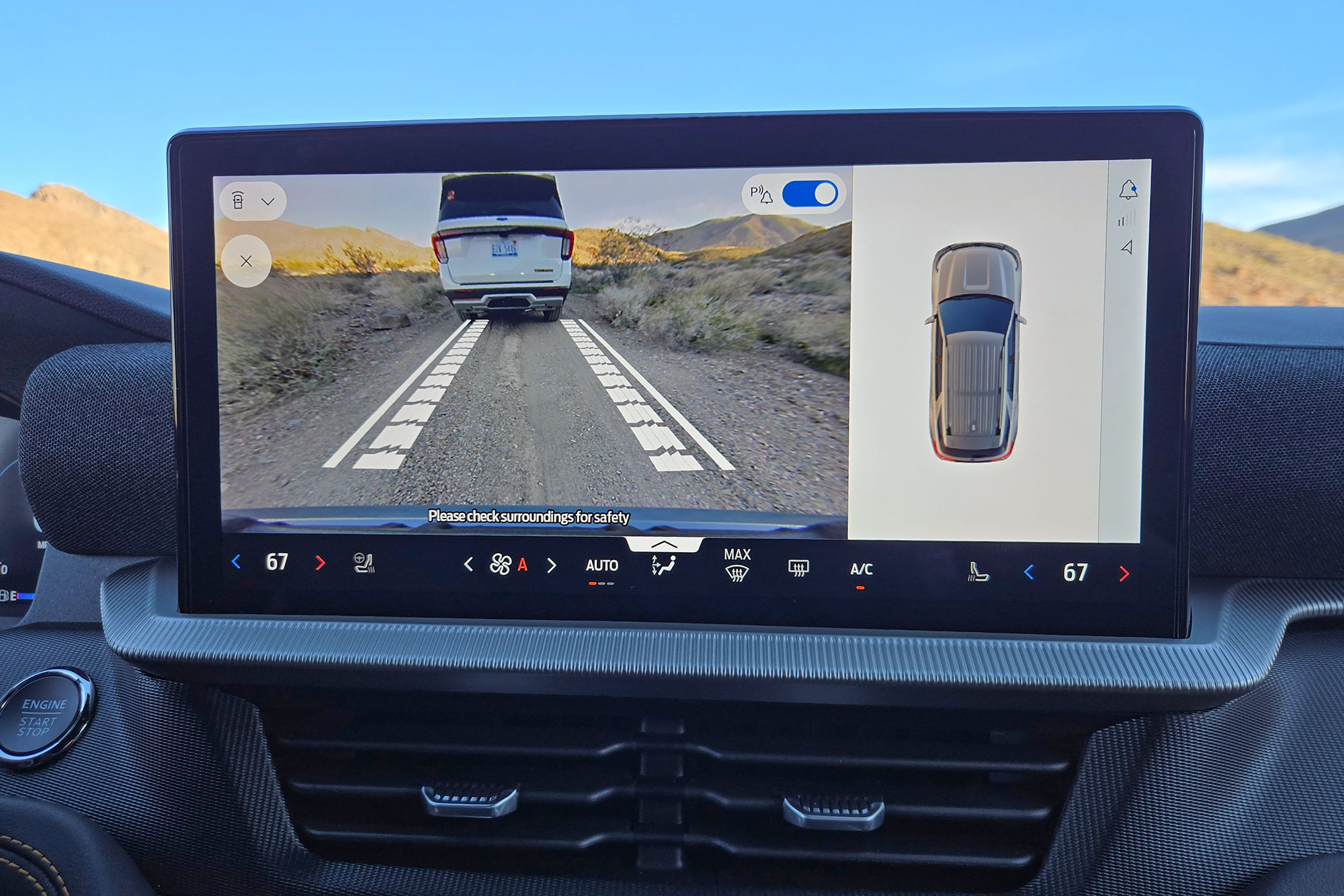 The 13.2-inch touchscreen displaying the front-facing trail camera with guide lines.