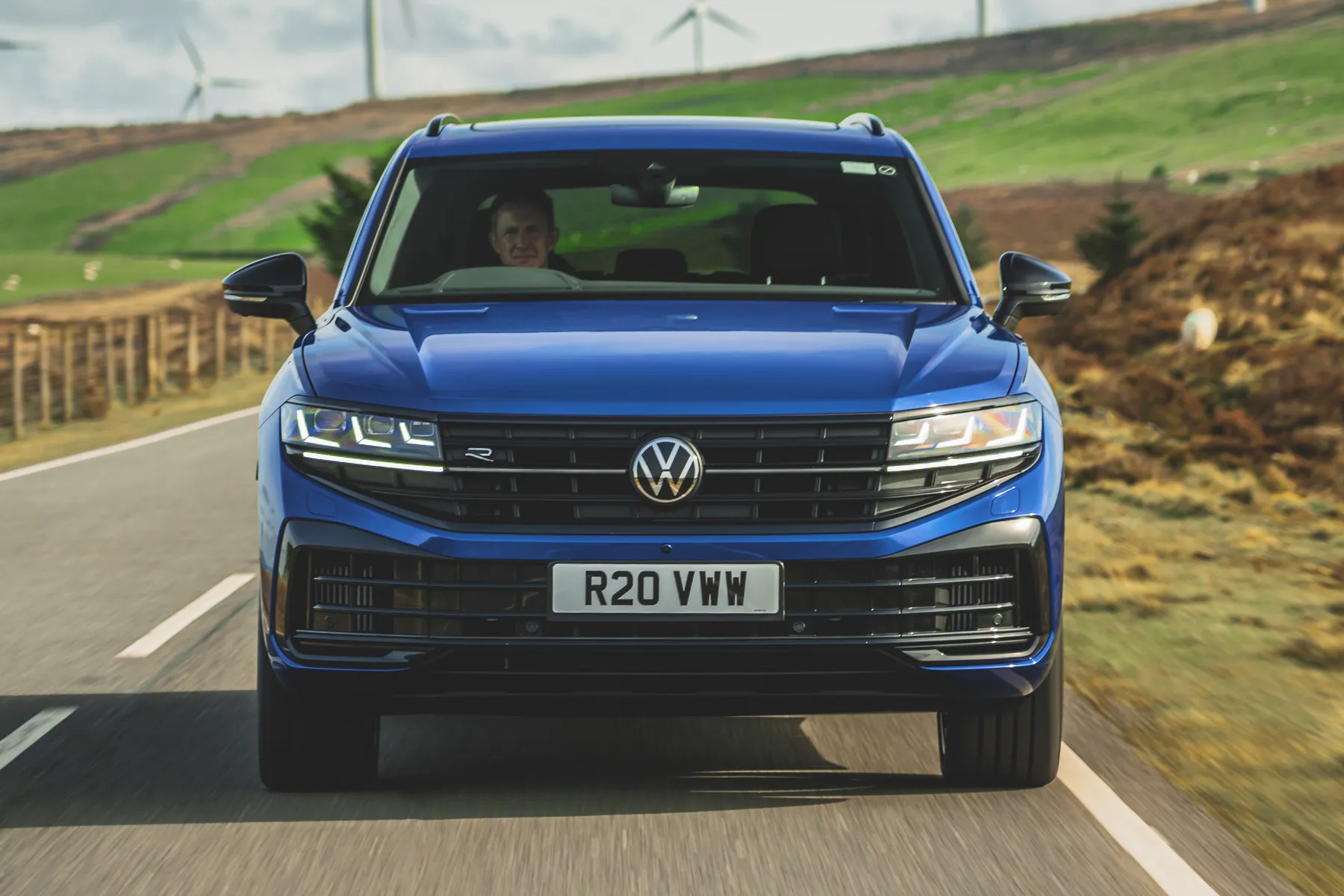 Front dynamic view of a Volkswagen SUV driving on an open road.