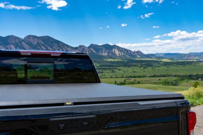 Macro detail of the leather-grain vinyl material and the mounting rail of a Bestop tonneau cover.