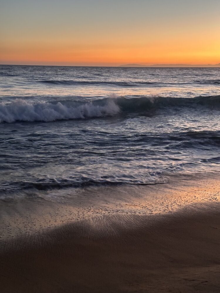 A white Jeep Wrangler driving over rugged granite terrain in the Idyllwild backcountry.