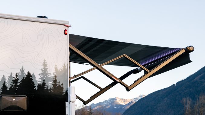 Close-up of the custom 'Overlander' mountain graphics on the rear of the camper.