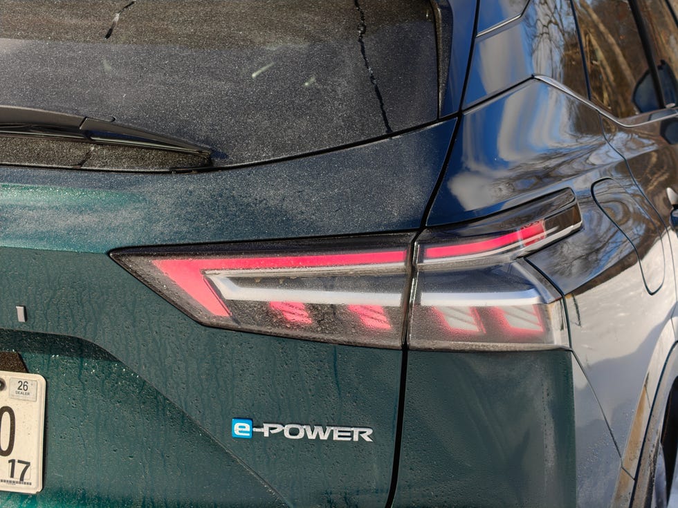 Front three-quarter view of a Nissan Qashqai e-Power on a coastal road.