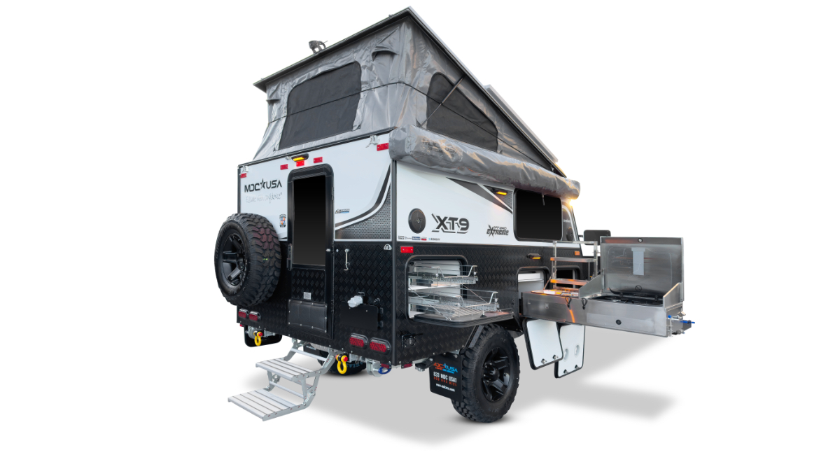 Side view of the compact MDC USA XT9 trailer showing its high ground clearance and rugged tires.