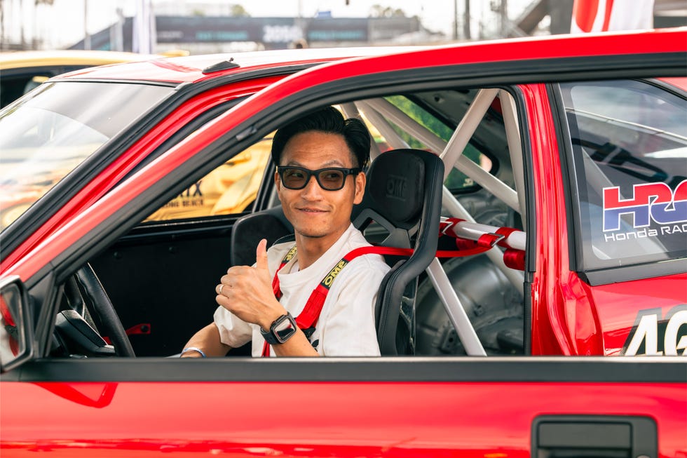 Professional driver Dai Yoshihara in racing suit.