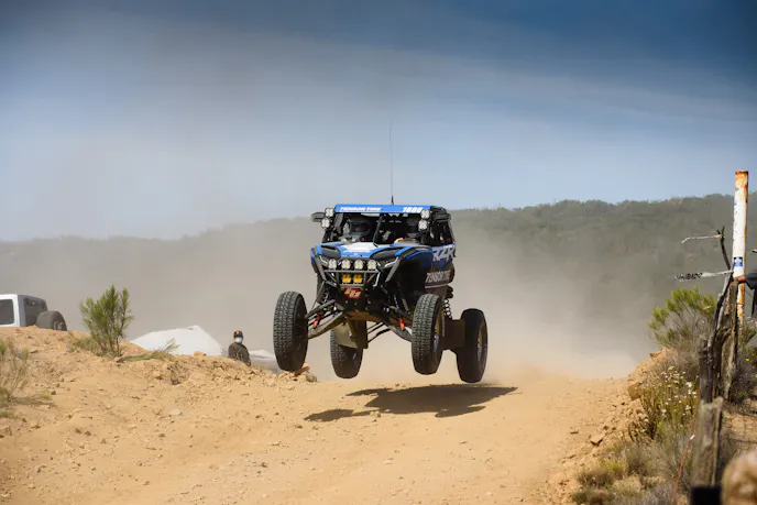 An action shot showing the suspension and performance of the RZR Pro R Factory in motion.