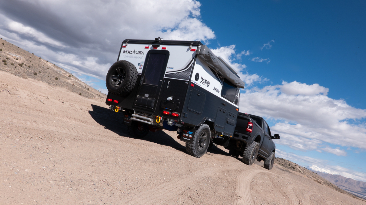 The MDC USA XT9 Off-Grid Extreme Edition parked in a rocky, mountainous wilderness area.