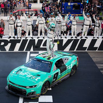 A field of stock cars competing during a NASCAR Cup Series event.