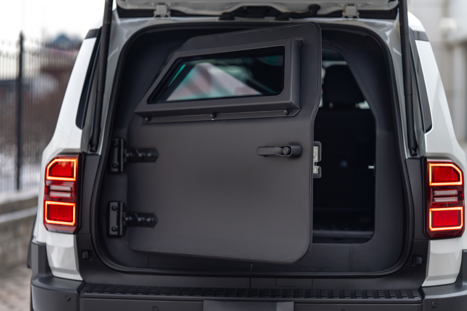 The engine compartment of an armored vehicle with visible ballistic shielding around key components.