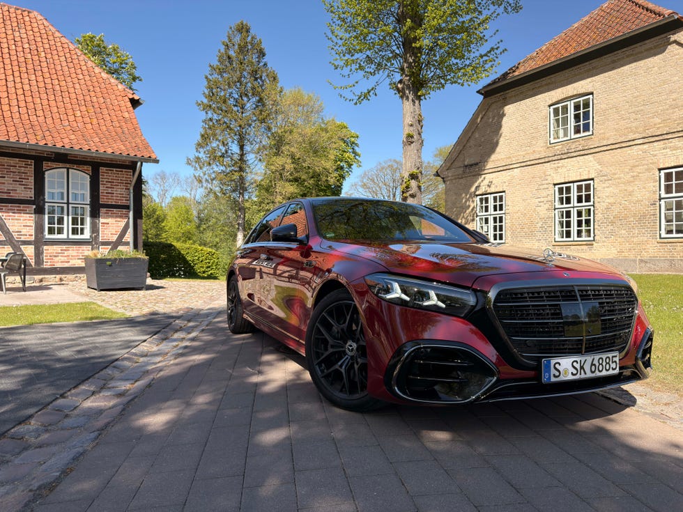 A 2027 Mercedes S-Class parked in front of traditional European architecture.