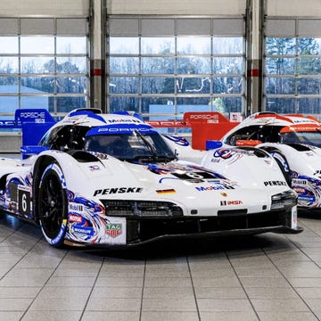 A Porsche 963 GTP car featuring a Mobil 1 tribute livery at a modern racing circuit.