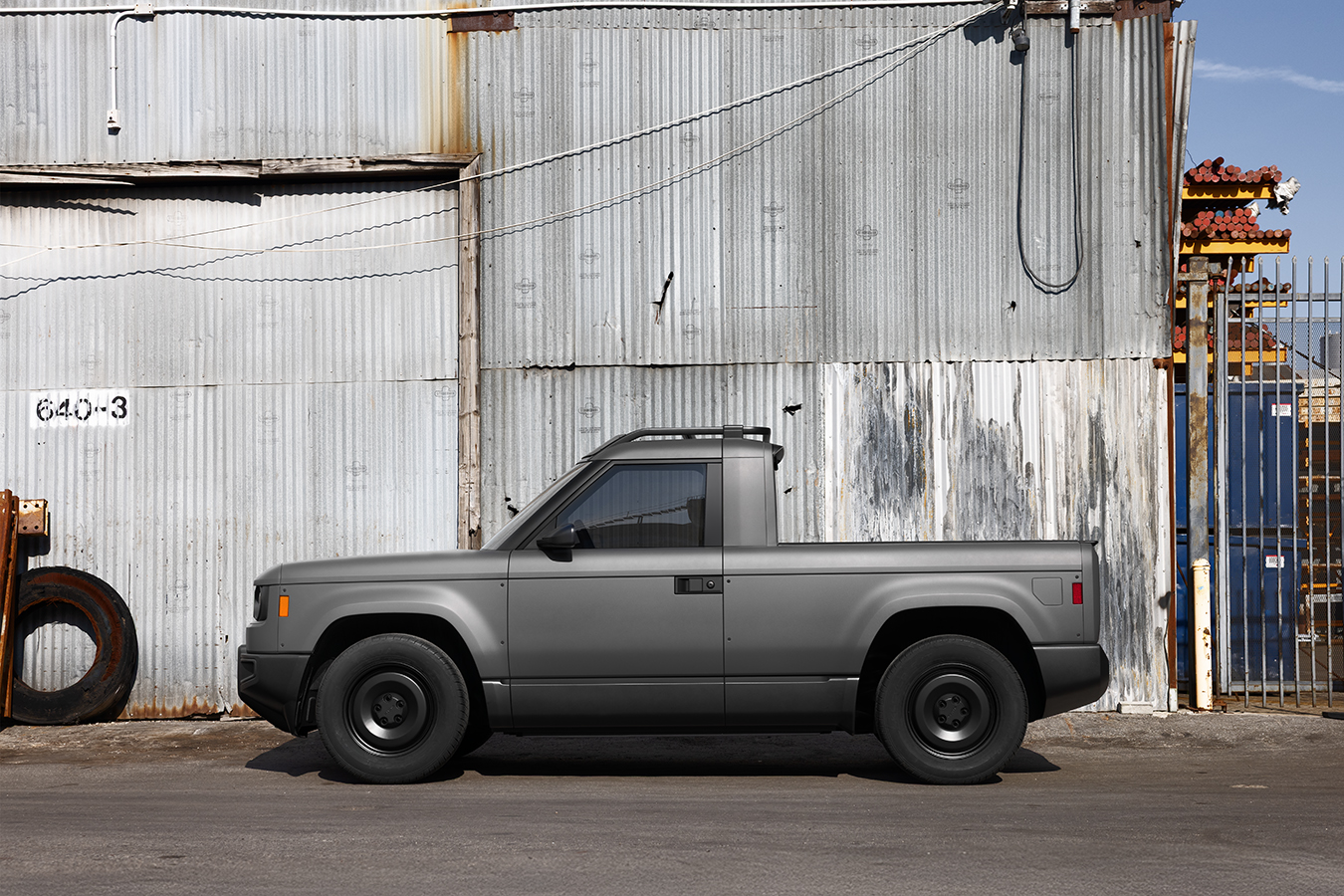 Side profile view of the compact Slate Auto electric pickup truck against a neutral background.