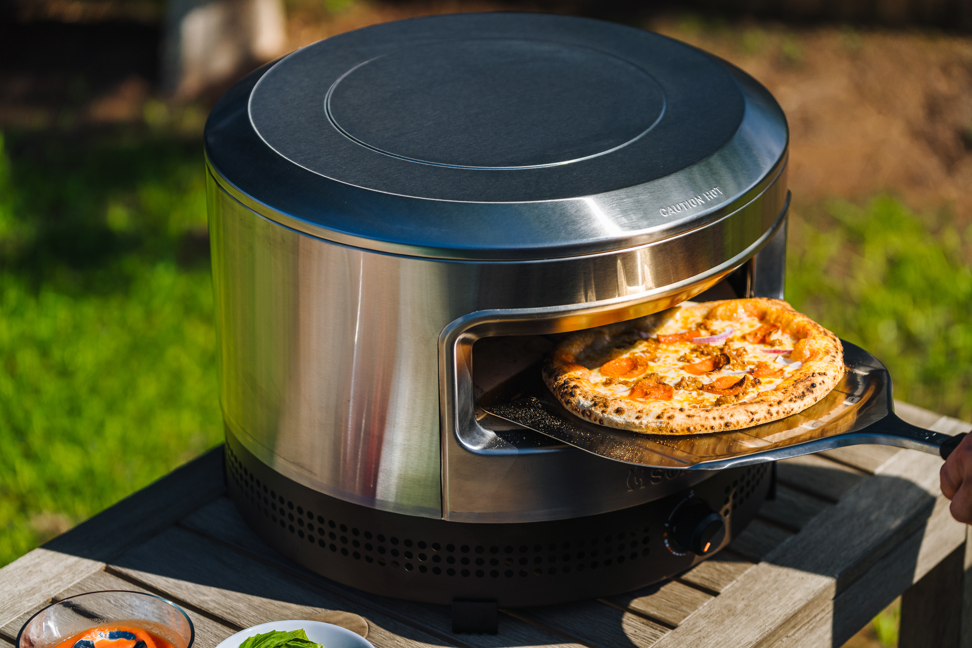 The Solo Stove Pi Prime gas-powered pizza oven showing its wide opening and sleek stainless steel exterior.
