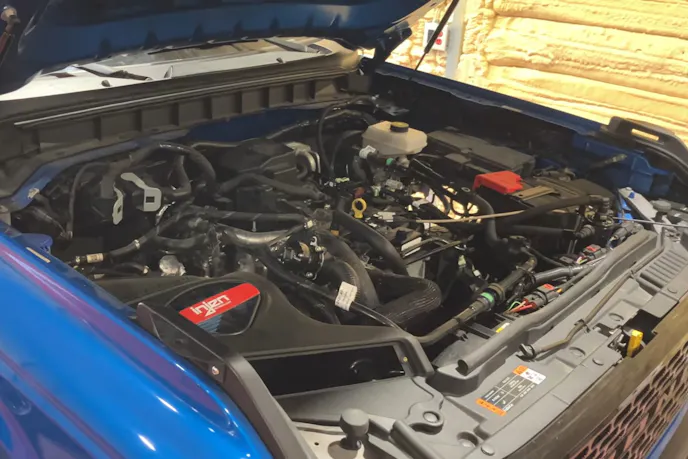 Under-hood view of a 2.3-liter EcoBoost Ford Bronco engine with modified intake components.