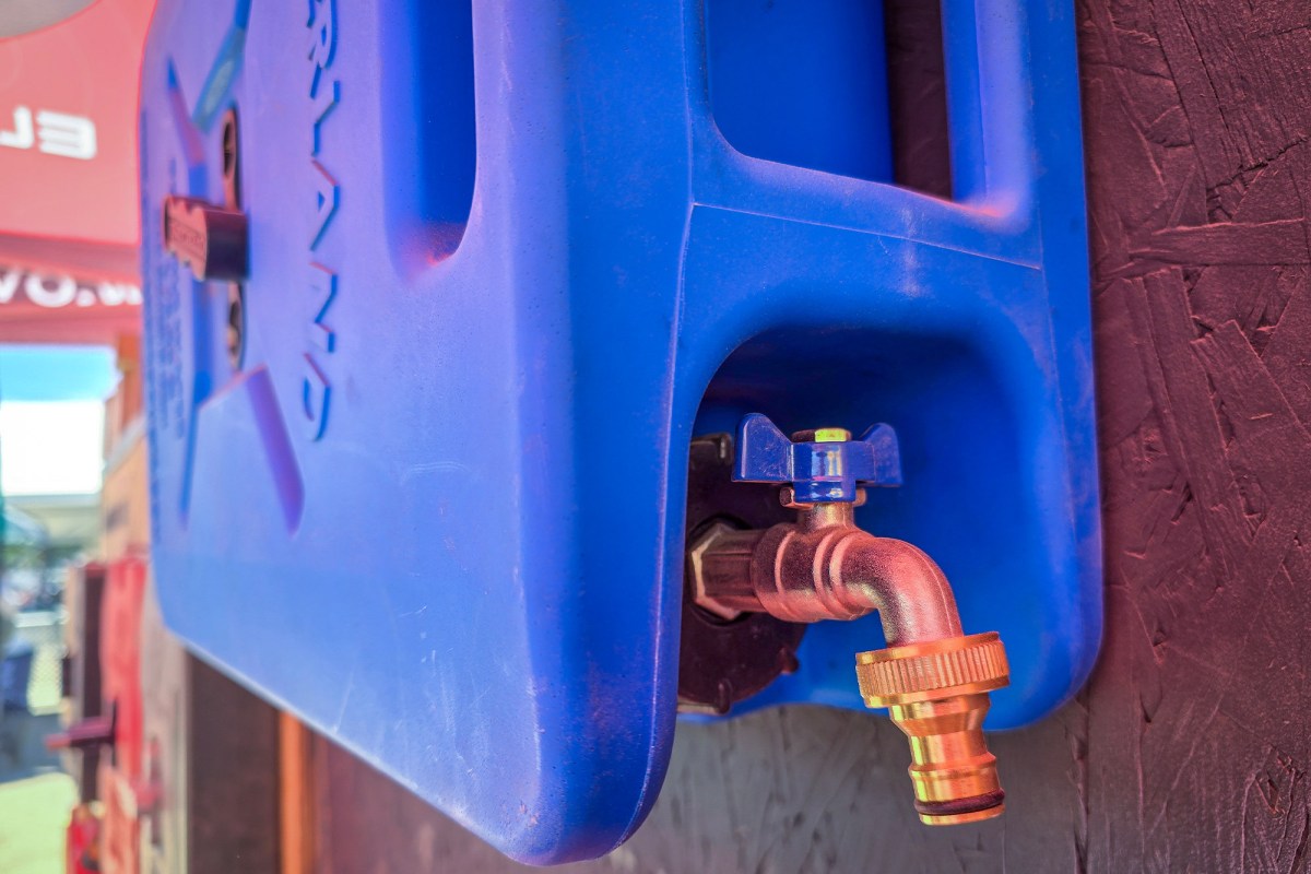 An Overland Fuel 20L water can with integrated self-venting cap and metal spigot.