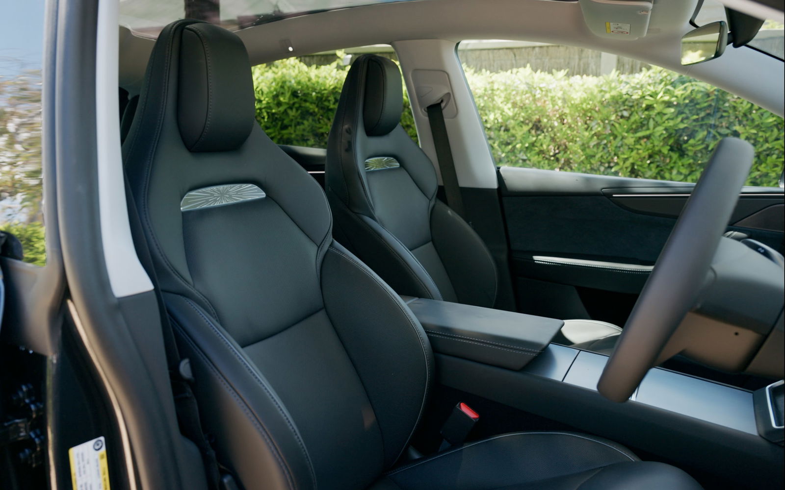 Interior view of the Tesla Model Y dashboard featuring carbon fiber trim and a clean minimalist layout.